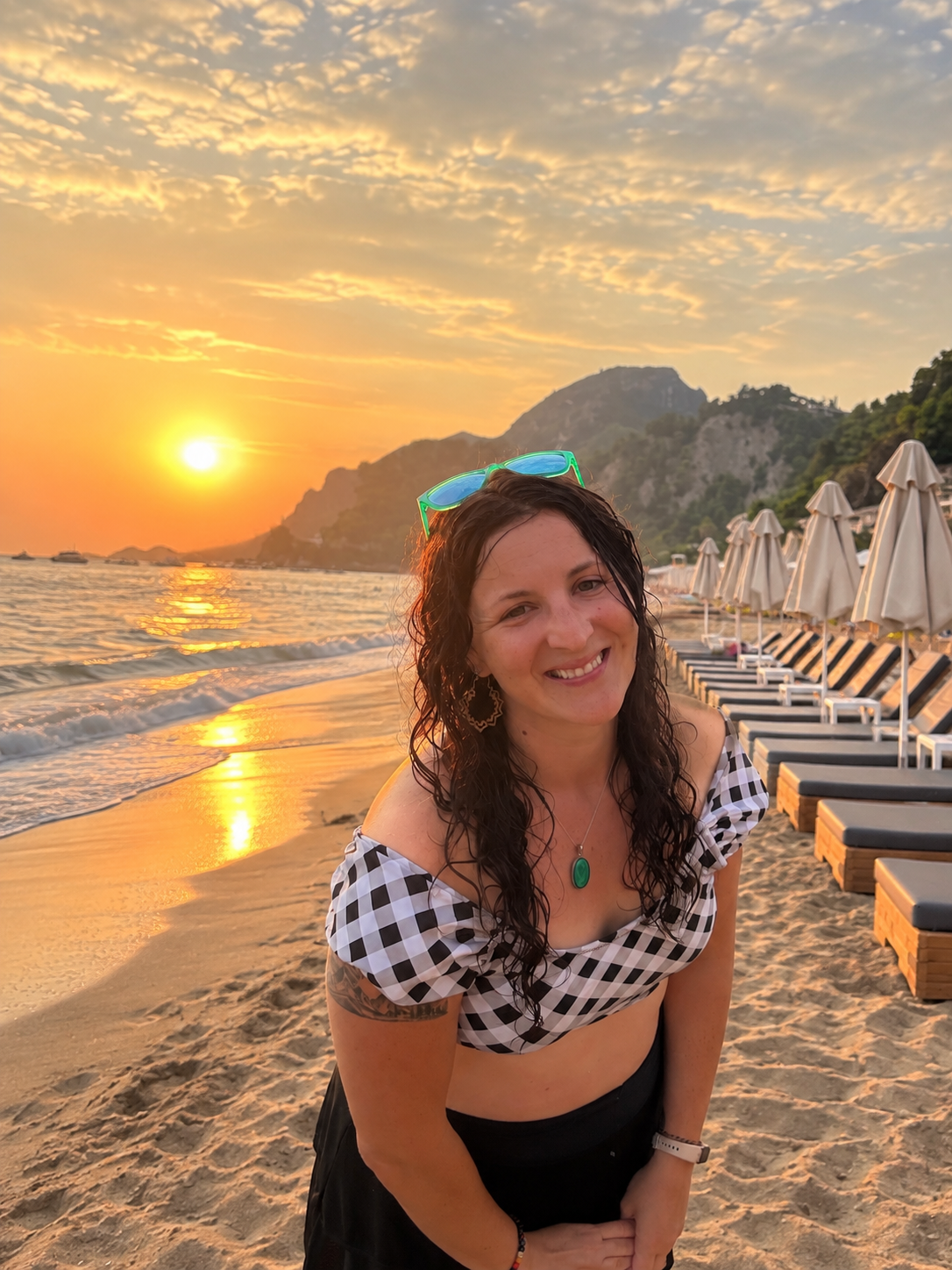 Traci Schneider at golden hour on the beach, warmth, ease, and room to breathe